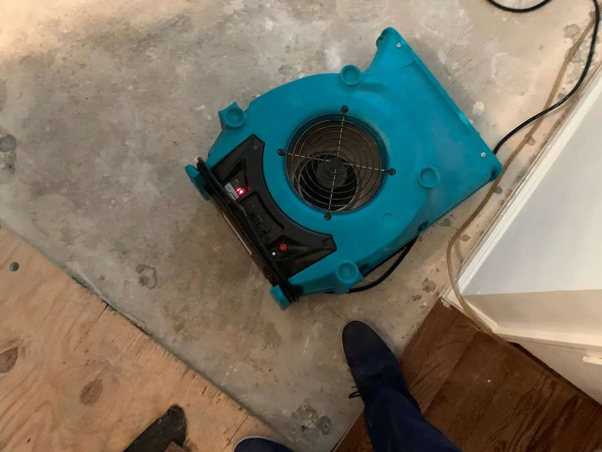 Air mover drying subfloor during Commercial Water Damage Restoration in Clemson